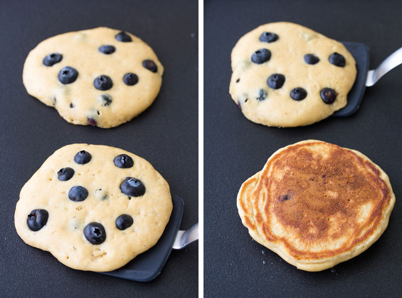 This easy blueberry pancakes recipe makes the best fluffy blueberry pancakes from scratch! These homemade pancakes are healthy, with just the right amount of sweet, juicy blueberries in them. Use fresh or frozen blueberries. They are perfect for a weekend breakfast! Cooking blueberry pancakes on a griddle, and flipping the pancakes.