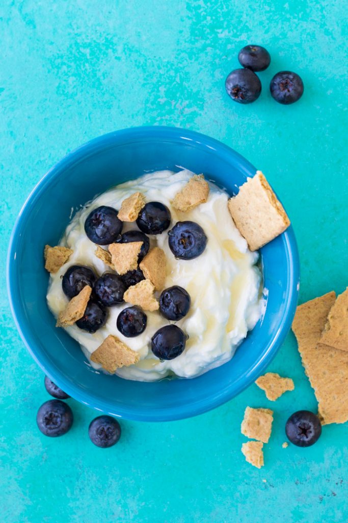 Easy yogurt bowl made with fruit and graham cracker.